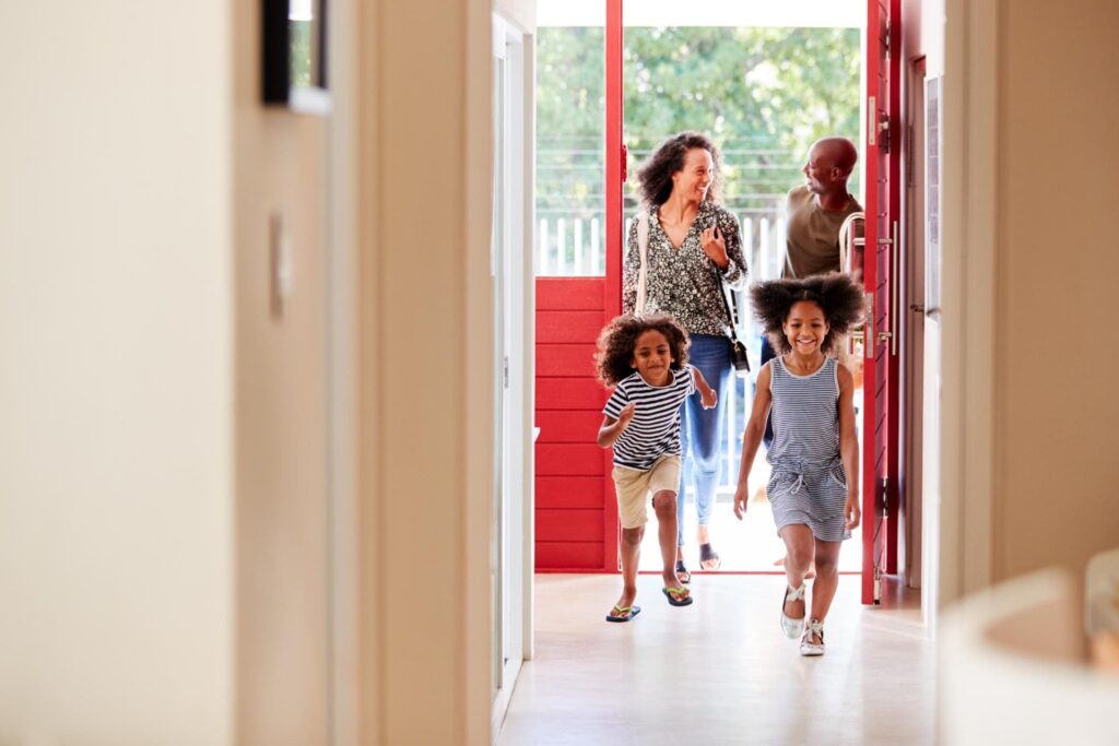 family returning home from shopping trip using